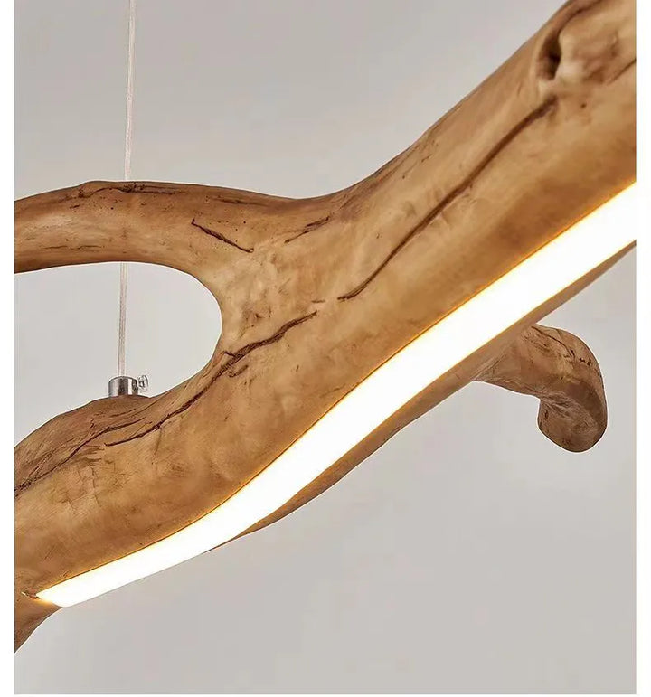 Suspension bois branche design bohème, éclairage LED intégré, ambiance chaleureuse et accueillante, style bohème ou éco-chic.